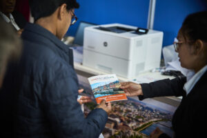 Two people looking at a flyer for the Copenhagen event